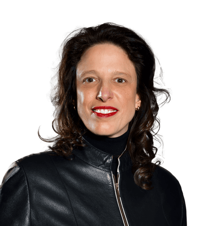 Portrait of a smiling woman with shoulder-length dark hair, wearing a black leather jacket and red lipstick.