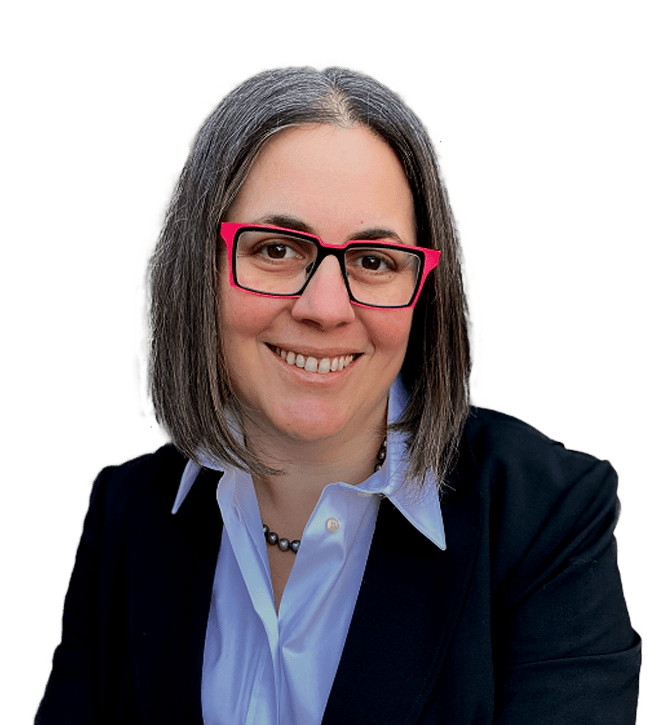 Professional headshot of a smiling woman with gray hair, pink-framed glasses, wearing a blue shirt and dark blazer.